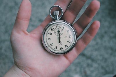 An image of a hand holding a stopwatch depicting saving time