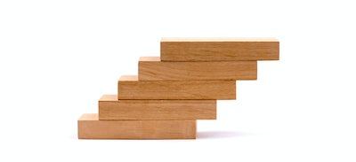A pile of wooden blocks laid over each other showcasing gradual SEO progress